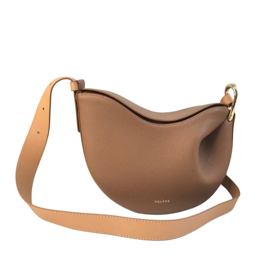 Polène Numéro Sept Bag (Category: Luxury Bags & Wallets) located in Caloocan City. Submitted by blazyoh (Listing ID 1422157106, Image 1). Description: - Polène Numéro Sept bag - Elegant tan color - Unique crescent shape - Adjustable long strap - Features gold-tone hardware - Crafted from high-quality leather - Subtle Polène logo - Suitable for daily use and special occasions.