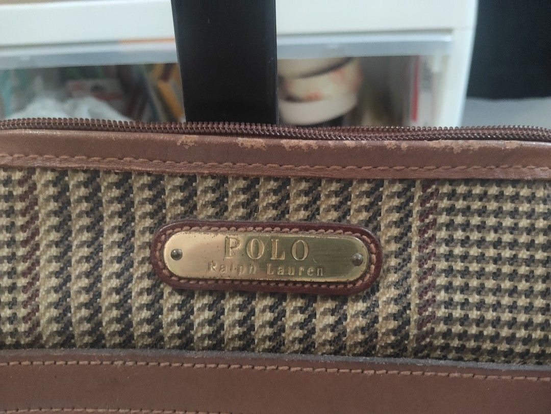 Polo Ralph Lauren Cosmetic Bag (Category: Luxury Bags & Wallets) located in Manila. Submitted by dcsago (Listing ID 1422159741, Image 2). Description: - Authentic Polo Ralph Lauren cosmetic bag - Classic plaid pattern - Brown leather accents - Secure zippered closure - Includes a small interior pocket - Convenient top handle - Features the iconic Polo Ralph Lauren logo.