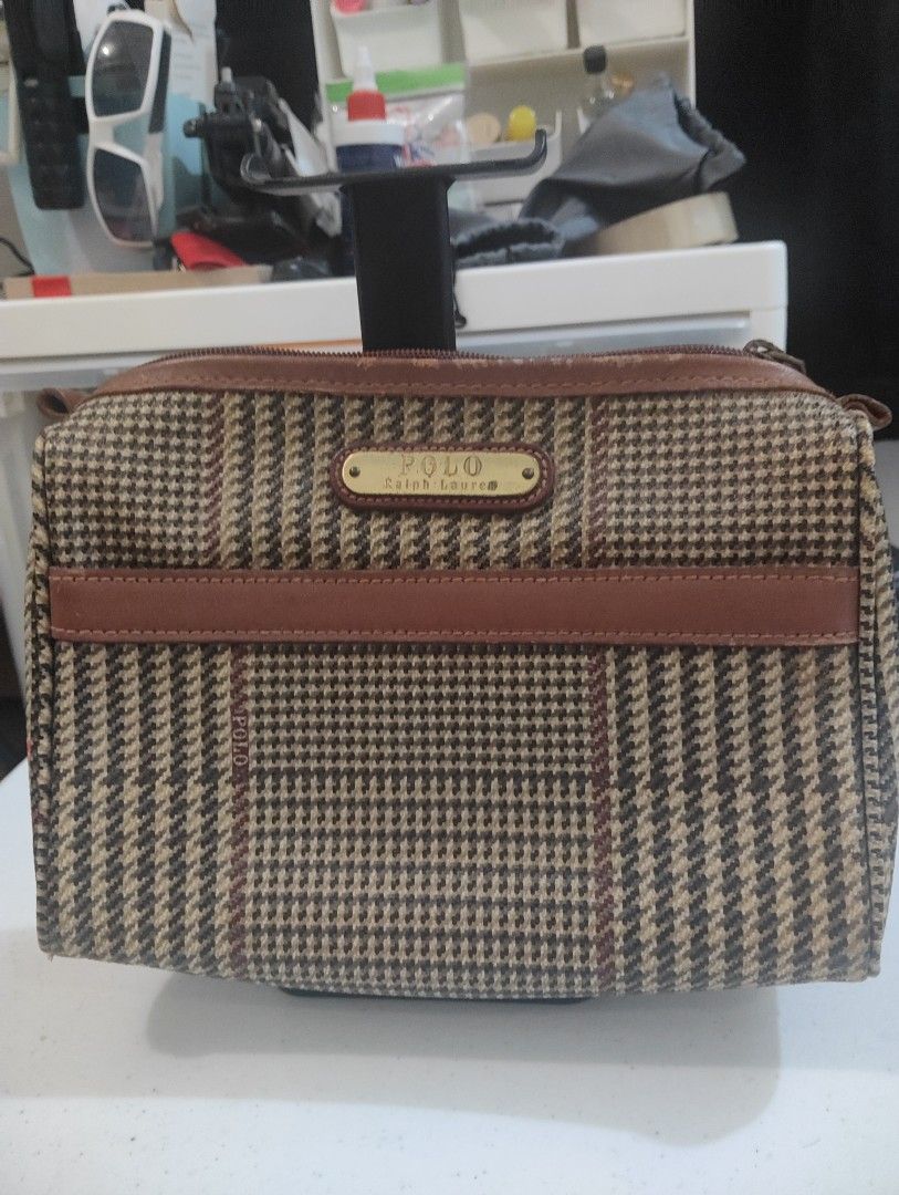 Polo Ralph Lauren Cosmetic Bag (Category: Luxury Bags & Wallets) located in Manila. Submitted by dcsago (Listing ID 1422159741, Image 1). Description: - Authentic Polo Ralph Lauren cosmetic bag - Classic plaid pattern - Brown leather accents - Secure zippered closure - Includes a small interior pocket - Convenient top handle - Features the iconic Polo Ralph Lauren logo.