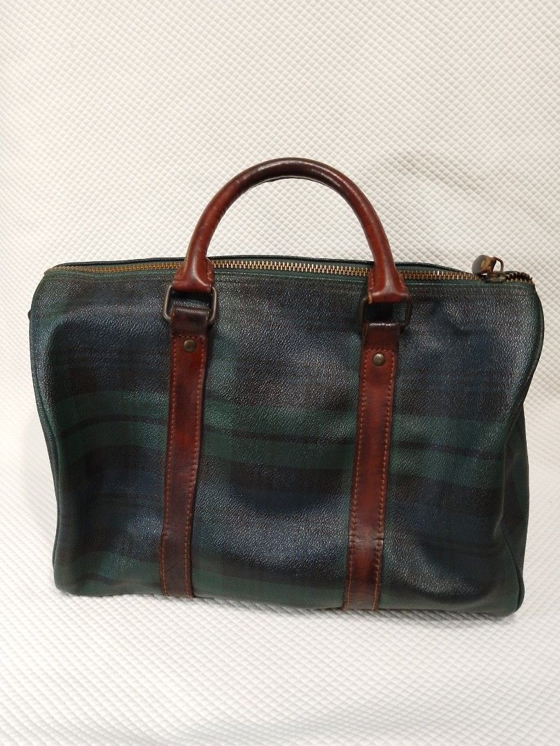 Polo Ralph Lauren Plaid Duffle Bag (Category: Luxury Bags & Wallets) located in Manila. Submitted by decorasyon (Listing ID 1422140023, Image 2). Description: - Vintage Polo Ralph Lauren duffle bag - Classic plaid pattern - Brown leather handles, trim, and accents - Features Polo Ralph Lauren leather tag - Zipper closure - Interior pocket - Shows wear on leather and hardware.
