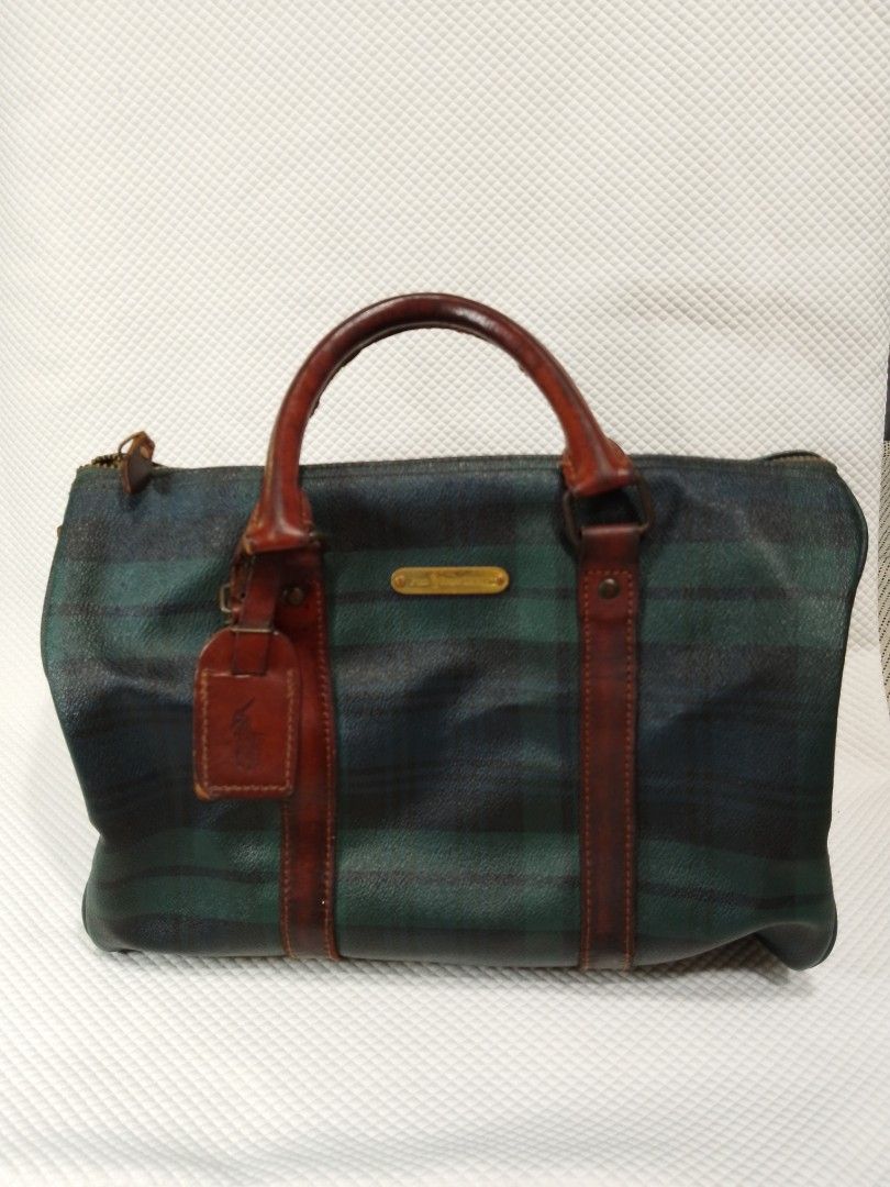 Polo Ralph Lauren Plaid Duffle Bag (Category: Luxury Bags & Wallets) located in Manila. Submitted by decorasyon (Listing ID 1422140023, Image 1). Description: - Vintage Polo Ralph Lauren duffle bag - Classic plaid pattern - Brown leather handles, trim, and accents - Features Polo Ralph Lauren leather tag - Zipper closure - Interior pocket - Shows wear on leather and hardware.