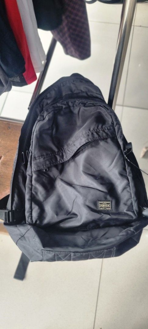 Porter-Yoshida & Co. Black Backpack (Category: Backpacks) located in Manila. Submitted by myno23lenel (Listing ID 1422086975, Image 1). Description: - Black Porter-Yoshida & Co. backpack - Multiple compartments for storage - Interior pocket with orange lining - Adjustable straps for a comfortable fit - Top handle for easy carrying - Features a small logo patch - "Made in Japan" label -Good Condition,signs of usage -Location Fairview.