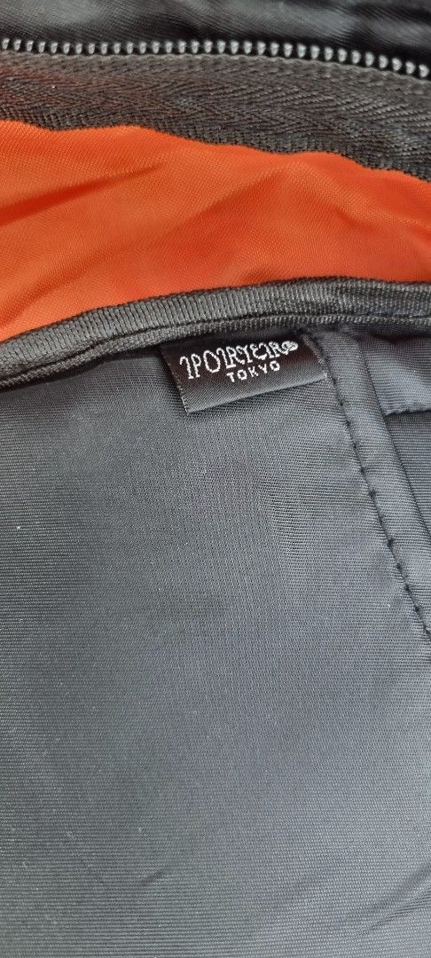 Porter-Yoshida & Co. Black Backpack (Category: Backpacks) located in Manila. Submitted by myno23lenel (Listing ID 1422086975, Image 2). Description: - Black Porter-Yoshida & Co. backpack - Multiple compartments for storage - Interior pocket with orange lining - Adjustable straps for a comfortable fit - Top handle for easy carrying - Features a small logo patch - "Made in Japan" label -Good Condition,signs of usage -Location Fairview.