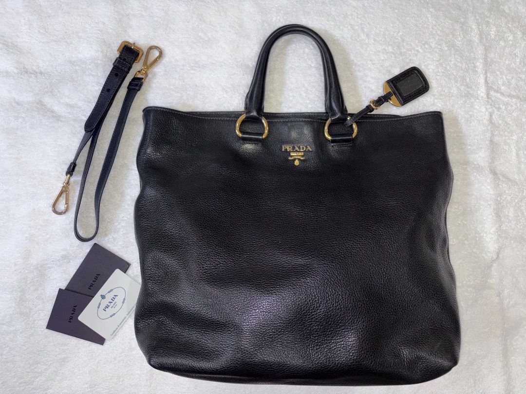 Prada Daino Vitello Leather Bag (Category: Luxury Bags & Wallets) located in Tagaytay City. Submitted by kyle870 (Listing ID 1422153482, Image 1). Description: - Authentic Prada bag - Black color with gold-tone hardware - Detachable shoulder strap included - Features interior pockets - Comes with luggage tag and authenticity cards - Spacious interior with Prada logo lining - Exterior shows some signs of wear -Can do Cavite/Manila meetups.