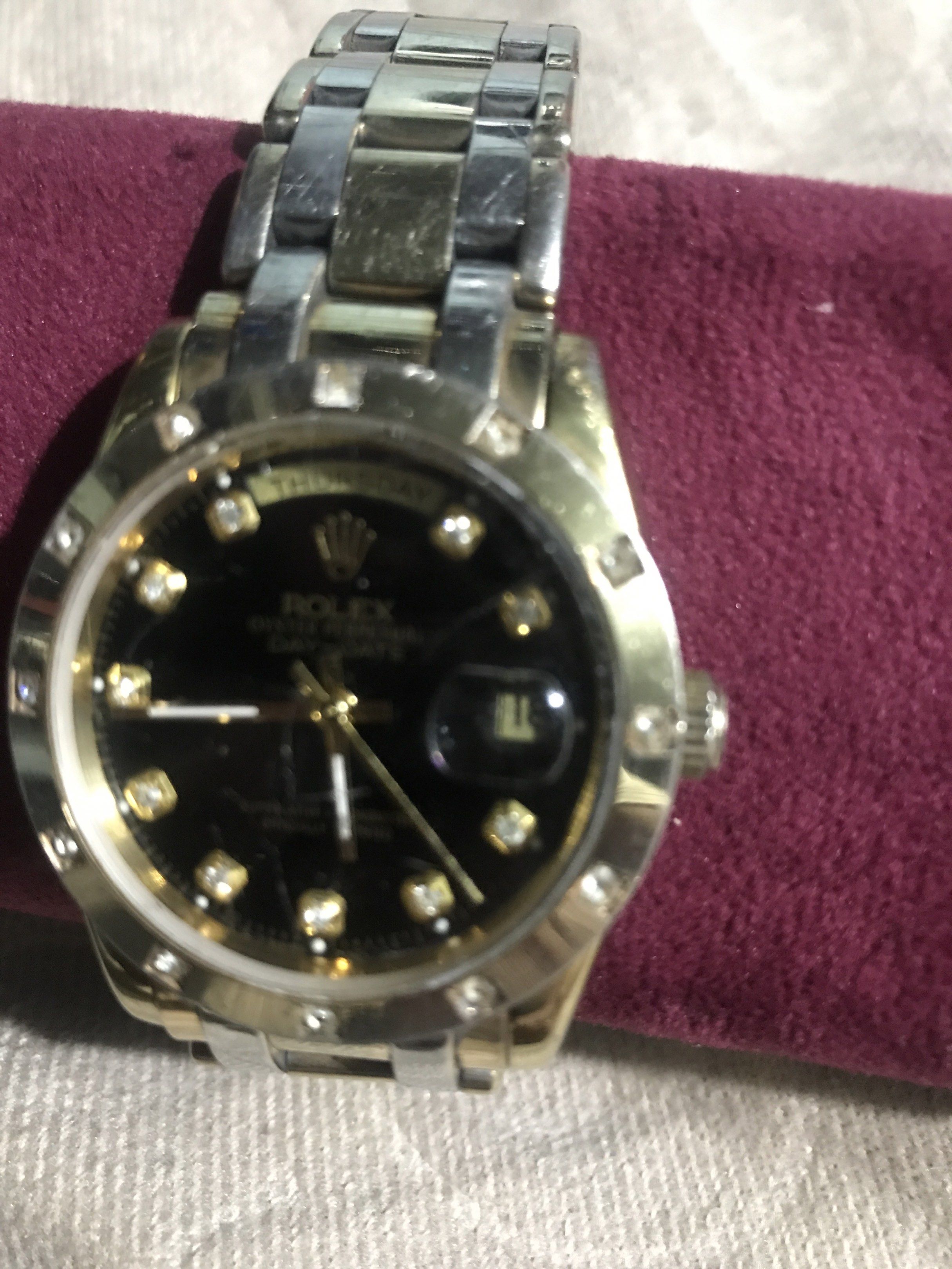 Rolex Day-Date Watch with Diamond Markers (Category: Luxury Watches) located in Baguio. Submitted by agozun61 (Listing ID 1422162603, Image 2). Description: - Rolex Day-Date watch - Black dial with diamond hour markers - Gold and silver-tone bracelet - Day and date display - Fluted bezel - In good working condition.