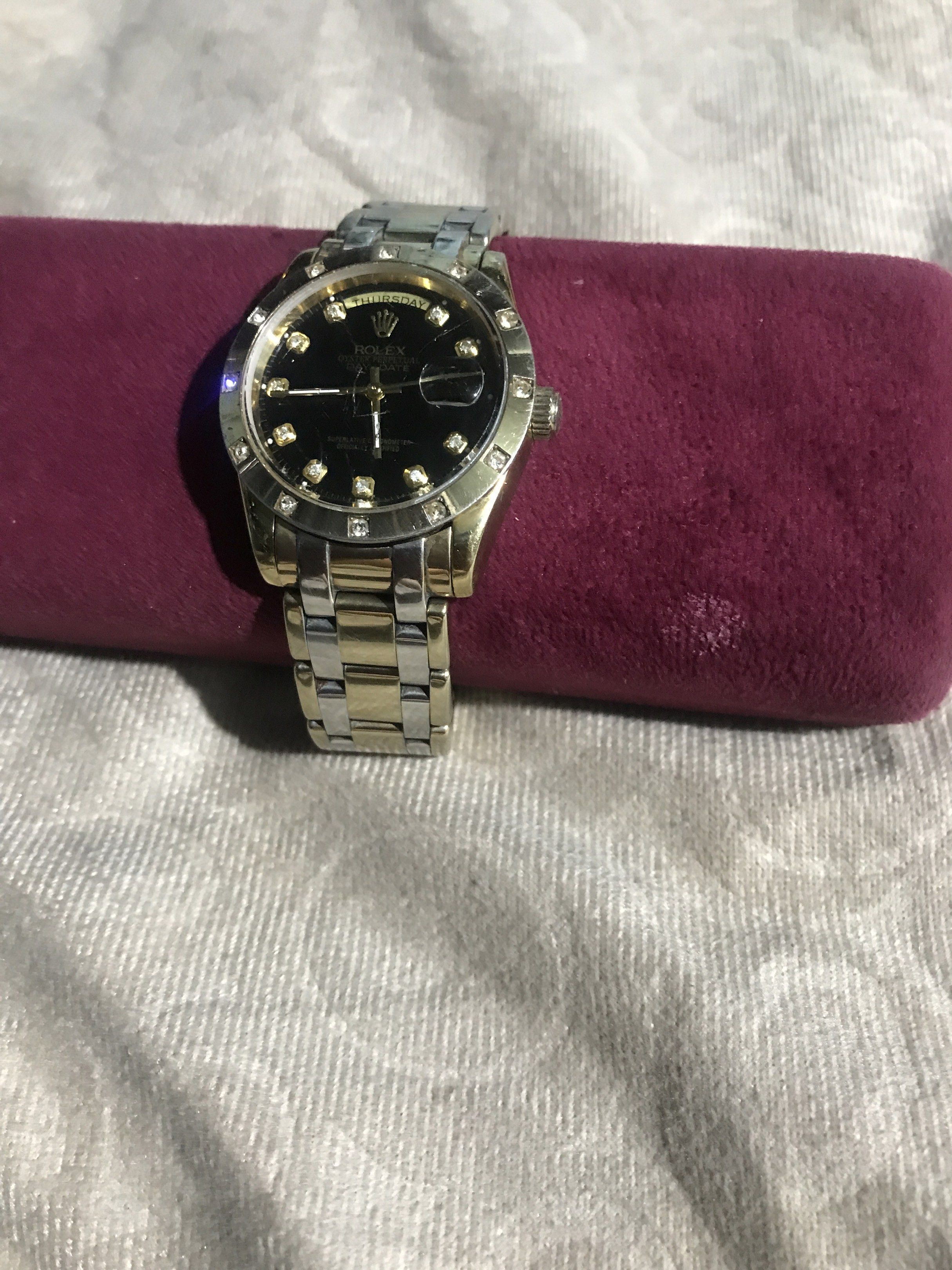 Rolex Day-Date Watch with Diamond Markers (Category: Luxury Watches) located in Baguio. Submitted by agozun61 (Listing ID 1422162603, Image 1). Description: - Rolex Day-Date watch - Black dial with diamond hour markers - Gold and silver-tone bracelet - Day and date display - Fluted bezel - In good working condition.
