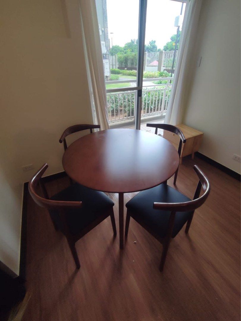 Round Dining Table (Category: Tables & Sets) located in Quezon City. Submitted by furniturefinds888 (Listing ID 1422182017, Image 2). Description: - Round dining table with 4 chairs - Dark wood table finish - Black chair seats - Modern design - Ideal for apartments and small dining areas - Stylish and comfortable.