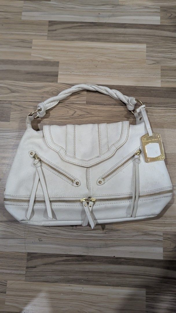 Samantha Thavasa White Handbag (Category: Luxury Bags & Wallets) located in Pasay City. Submitted by aatapparelshop (Listing ID 1422177860, Image 1). Description: - White Samantha Thavasa handbag - Braided handle - Multiple zippered compartments - Gold-tone brand tag - Fabric lining - Magnetic closure.