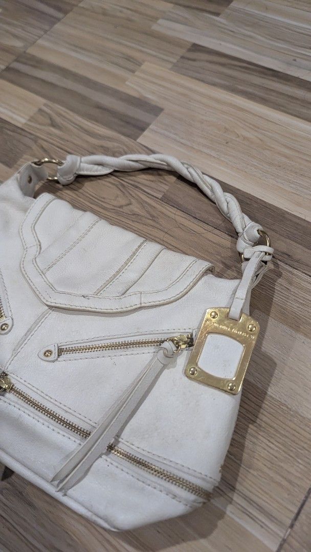 Samantha Thavasa White Handbag (Category: Luxury Bags & Wallets) located in Pasay City. Submitted by aatapparelshop (Listing ID 1422177860, Image 2). Description: - White Samantha Thavasa handbag - Braided handle - Multiple zippered compartments - Gold-tone brand tag - Fabric lining - Magnetic closure.