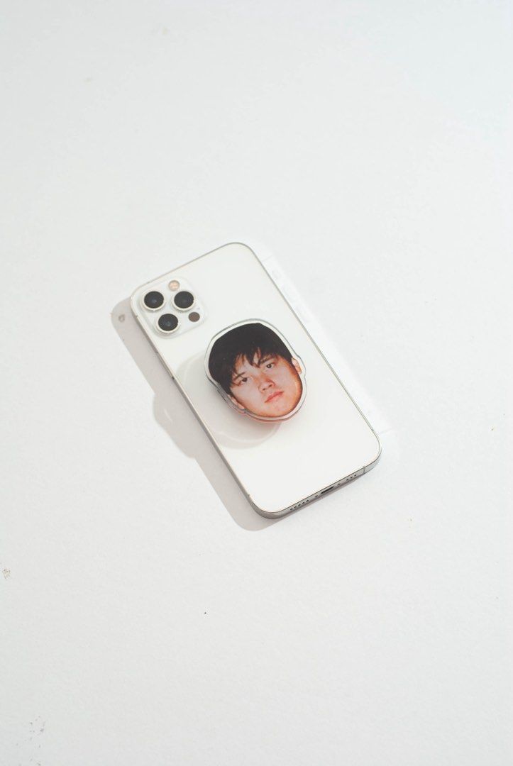Shohei Ohtani Griptok / Popsocket (Category: Mounts & Holders) located in Quezon City. Submitted by savespaces (Listing ID 1422183788, Image 2). Description: Customized Shohei Ohtani popsockets • brand new, with protective plastics on both sides of Shohei’s face • 2 left • comes with the “airbag” hahaha • material: clear acrylic • can double as phone stand for whenever you’re binge watching Can send more photos thru chat!.