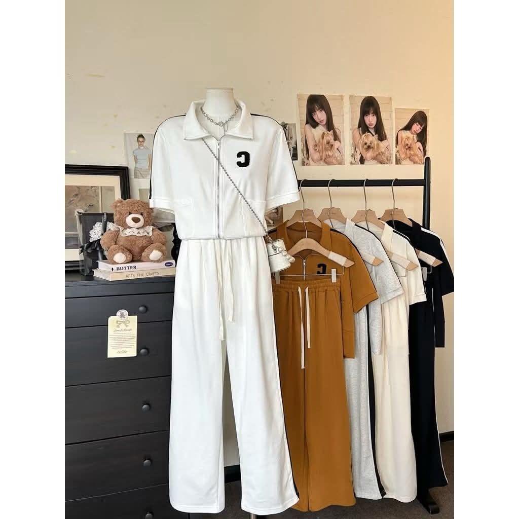 Tracksuit Set with Letter C (Category: Sets & Coordinates) located in Manila. Submitted by raredeer-4deb4e (Listing ID 1422104535, Image 2). Description: - Stylish tracksuit set - Collared zip-up top with short sleeves and "C" detail - Wide-leg pants with drawstring waist - Available colors: mustard, white, grey, black - Perfect for casual wear.