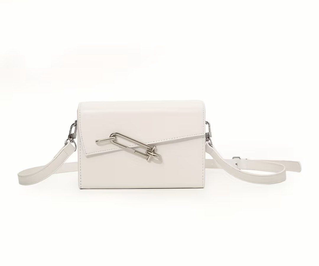 White Crossbody Bag with Silver Chain (Category: Cross-body Bags) located in Quezon City. Submitted by pjrosetase (Listing ID 1422137231, Image 1). Description: - White crossbody bag - Rectangular shape with flap closure - Silver chain detail - Detachable and adjustable shoulder strap - Smooth, leather-like material - Clean, minimalist design - Ideal for everyday or special events.
