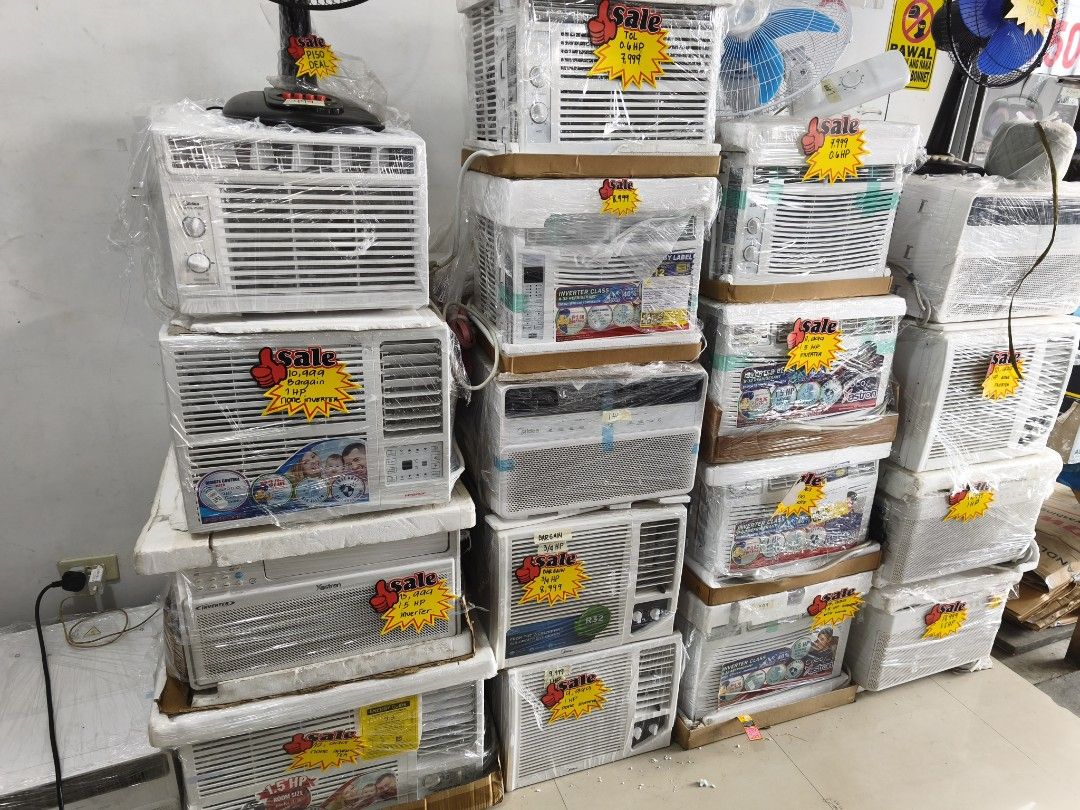 Window Type Air Conditioner - Sale! (Category: Air Conditioning and Heating) located in Makati City. Submitted by budgetappliance (Listing ID 1422196133, Image 1). Description: - Window type air conditioners for sale. - Units are white in color. - Wrapped in protective plastic. - Sale tags are visible on some units. - Please inquire for specific models and pricing..