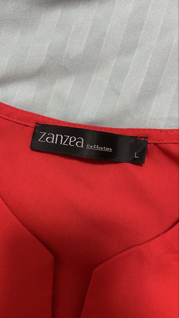 Zanzea Red Sleeveless Dress (Category: Dresses) located in Cainta. Submitted by ishatglav (Listing ID 1422228403, Image 3). Description: - Zanzea red sleeveless dress - Midi length - Size: L - Features a button-down front - Side zipper closure.