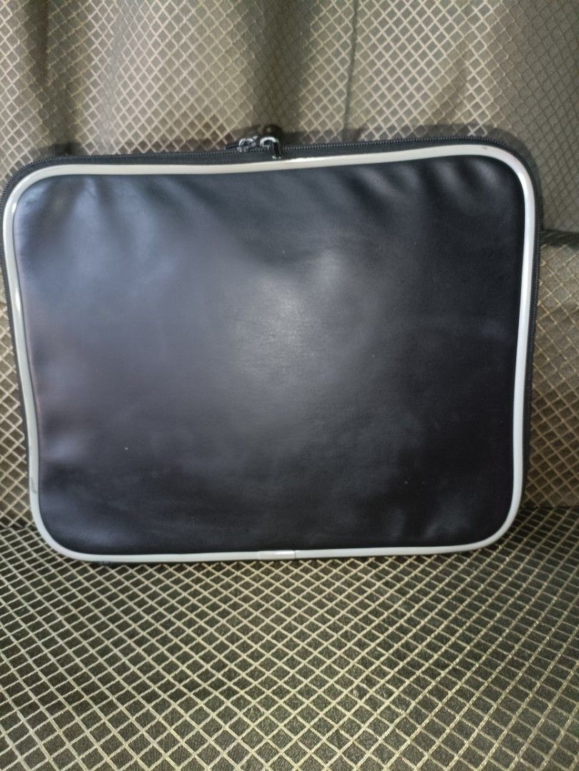 Zero Shock Laptop Sleeve (Category: Laptop Bags & Sleeves) located in San Pedro. Submitted by elevens_online_thrift_shop (Listing ID 1422107218, Image 3). Description: Zero Shock laptop sleeve features a black exterior with a white trim and a zipper closure. The interior is padded for added protection. It has a front pocket for accessories. The sleeve is designed to protect your laptop from shocks and impacts. The Zero Shock logo is visible on th
