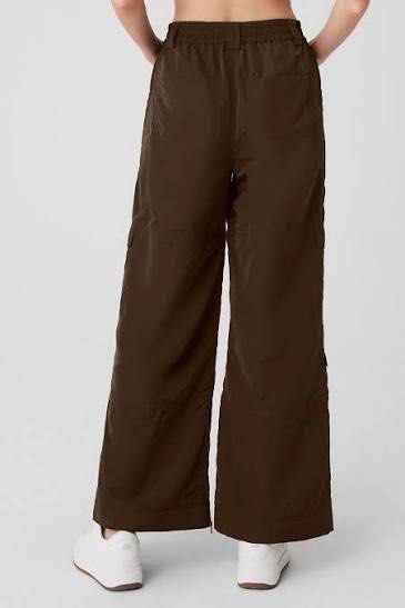Alo Yoga Cargo Pants - Brown (Category: Activewear) located in Singapore. Submitted by haruxoneday (Listing ID 1422349599, Image 3). Description: - Alo Yoga high waisted ski moto pants - Size M (US8-10) - Espresso Brown color - Wide-leg fit - Multiple pockets - Ankle zippers for adjustable fit - Suitable for casual wear and light activities Worn once - however the waist sizing is too large for me. I re-purchased in size S. RTP: SGD220 Open to tra
