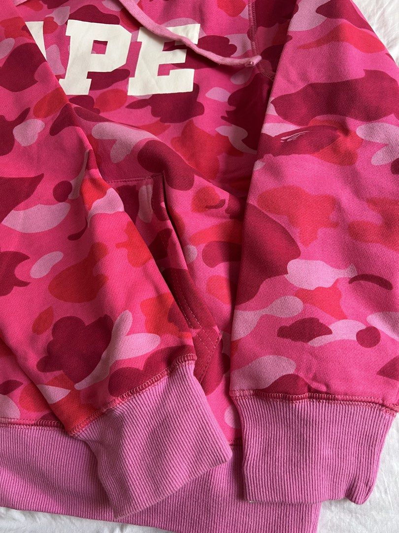BAPE Pink Camo Hoodie (Category: Hoodies) located in Marikina City. Submitted by helpmedeclutter.ml (Listing ID 1422259134, Image 3). Description: BAPE hoodie in a vibrant pink camo pattern. Features the iconic BAPE logo across the chest. Includes a hood with drawstrings and a kangaroo pocket. The hoodie has ribbed cuffs and hem. Size M. Comes with tags. Marikina/Manila area Gcash.
