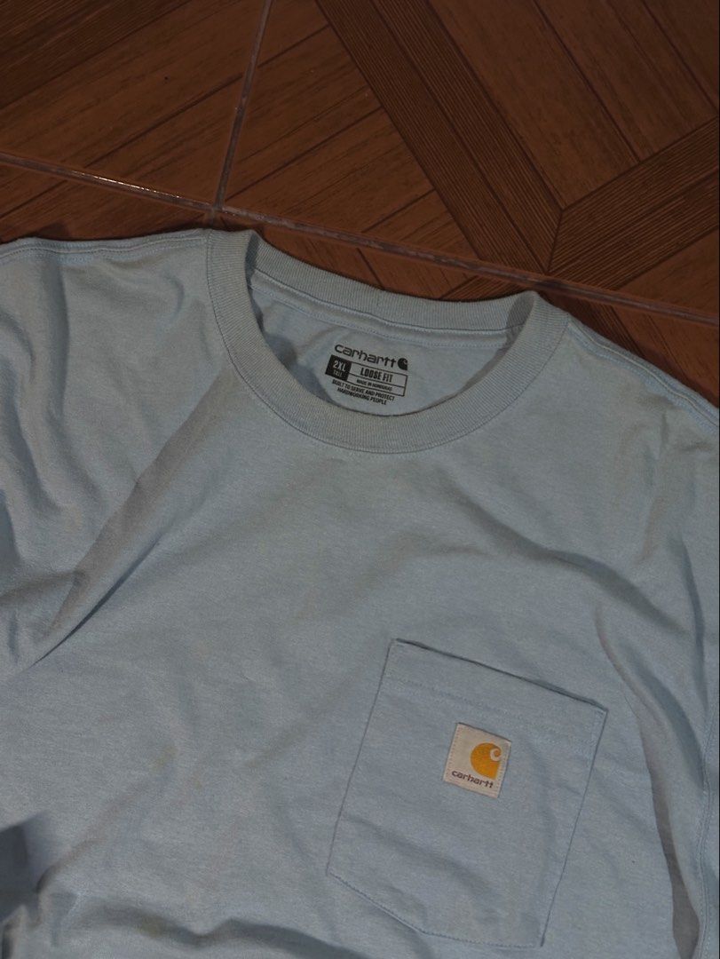 Carhartt Pocket Tee - 2XL Tall (Category: Tshirts & Polo Shirts ) located in Makati City. Submitted by rainner_31 (Listing ID 1422245948, Image 2). Description: - Carhartt pocket tee - Light blue color - Features chest pocket with Carhartt logo - Size: 2XL Tall - Material: Cotton/Polyester blend - Fit: Loose - Neckline: Crew - Sleeves: Short - Season: Fall 2022 CARHARTT COLOR RATE: 9.8/10 Excellent Condition DIMES: W- 28 L- 37 SIZE 2XL .