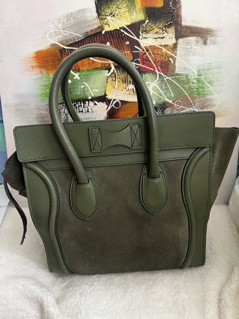 Celine Luggage Handbag Olive Green (Category: Luxury Bags & Wallets) located in Paranaque City. Submitted by glenjonluxuryfinds2 (Listing ID 1422366995, Image 2). Description: - Authentic Celine Luggage handbag - Color: Olive Green - Exterior: Suede and leather - Closure: Zip - Handles: Double - Interior: Zip pocket - Hardware: Gold-toned - Features Celine Paris logo - Condition: Shows wear on handles and corners.