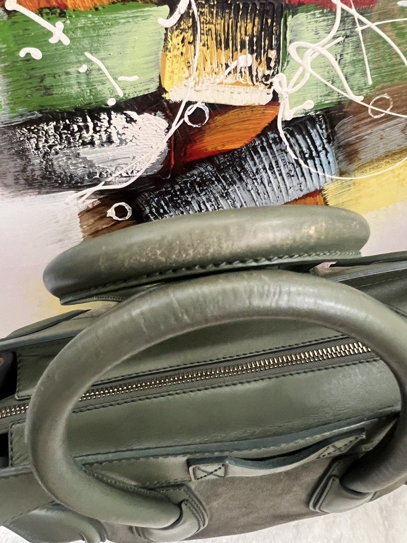 Celine Luggage Handbag Olive Green (Category: Luxury Bags & Wallets) located in Paranaque City. Submitted by glenjonluxuryfinds2 (Listing ID 1422366995, Image 3). Description: - Authentic Celine Luggage handbag - Color: Olive Green - Exterior: Suede and leather - Closure: Zip - Handles: Double - Interior: Zip pocket - Hardware: Gold-toned - Features Celine Paris logo - Condition: Shows wear on handles and corners.