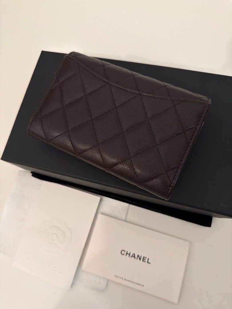 Chanel Classic Card Holder Wallet (Category: Luxury Bags & Wallets) located in Manila. Submitted by justabagxoxo (Listing ID 1422268958, Image 3). Description: - Authentic Chanel card holder - Dark brown color - Iconic quilted design - Features the CC logo - Includes original box, dust bag, and authenticity card - Multiple card slots - Zippered compartment - Stylish and practical accessory.