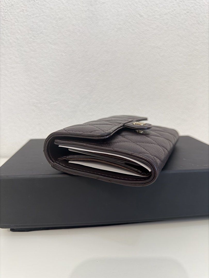 Chanel Classic Card Holder Wallet (Category: Luxury Bags & Wallets) located in Manila. Submitted by justabagxoxo (Listing ID 1422268958, Image 2). Description: - Authentic Chanel card holder - Dark brown color - Iconic quilted design - Features the CC logo - Includes original box, dust bag, and authenticity card - Multiple card slots - Zippered compartment - Stylish and practical accessory.