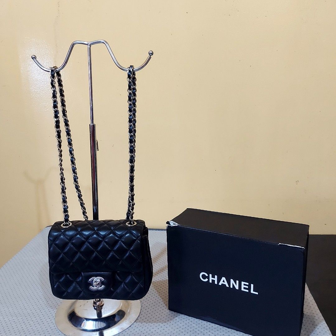 Chanel Mini Flap Bag Black (Category: Luxury Bags & Wallets) located in La Trinidad. Submitted by marksols (Listing ID 1422244657, Image 2). Description: - Chanel Mini Flap Bag - Black, quilted design - Chain strap - Includes: Box, dust bag, authenticity card, and ribbon - Red interior lining with zipper pocket - Made in Italy - Serial number visible.