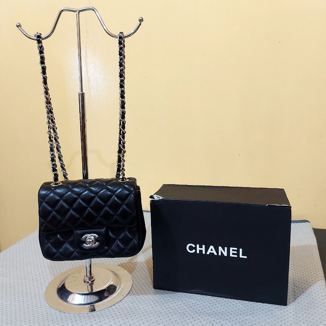 Chanel Mini Flap Bag Black (Category: Luxury Bags & Wallets) located in La Trinidad. Submitted by marksols (Listing ID 1422244657, Image 1). Description: - Chanel Mini Flap Bag - Black, quilted design - Chain strap - Includes: Box, dust bag, authenticity card, and ribbon - Red interior lining with zipper pocket - Made in Italy - Serial number visible.