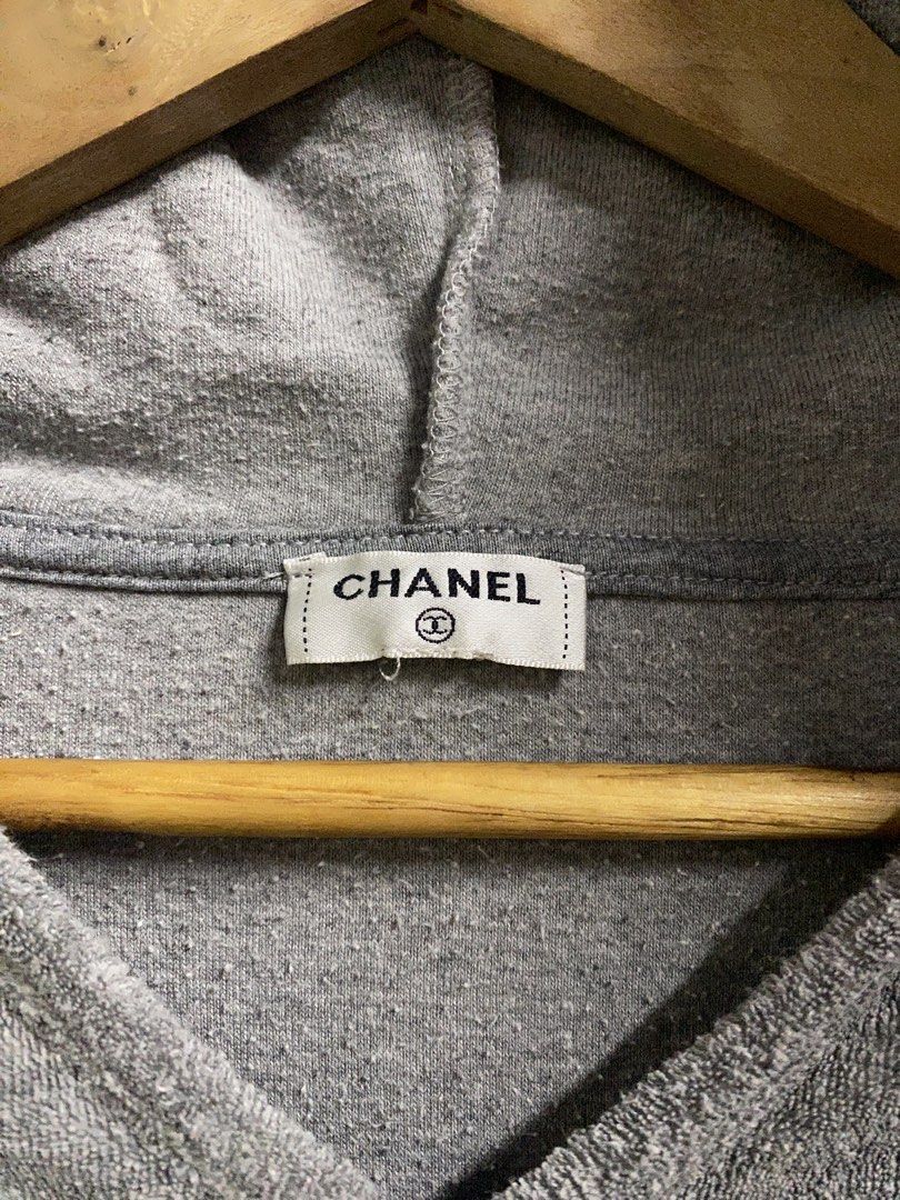 Chanel Terry Cloth Hoodie (Category: Luxury Apparel) located in Dagupan City. Submitted by junkfiles. (Listing ID 1422385515, Image 2). Description: - Chanel gray terry cloth hoodie - Features a large Chanel logo on the front pocket - V-neck design - Hooded - White trim on cuffs and hem - Chanel logo on inside tag.