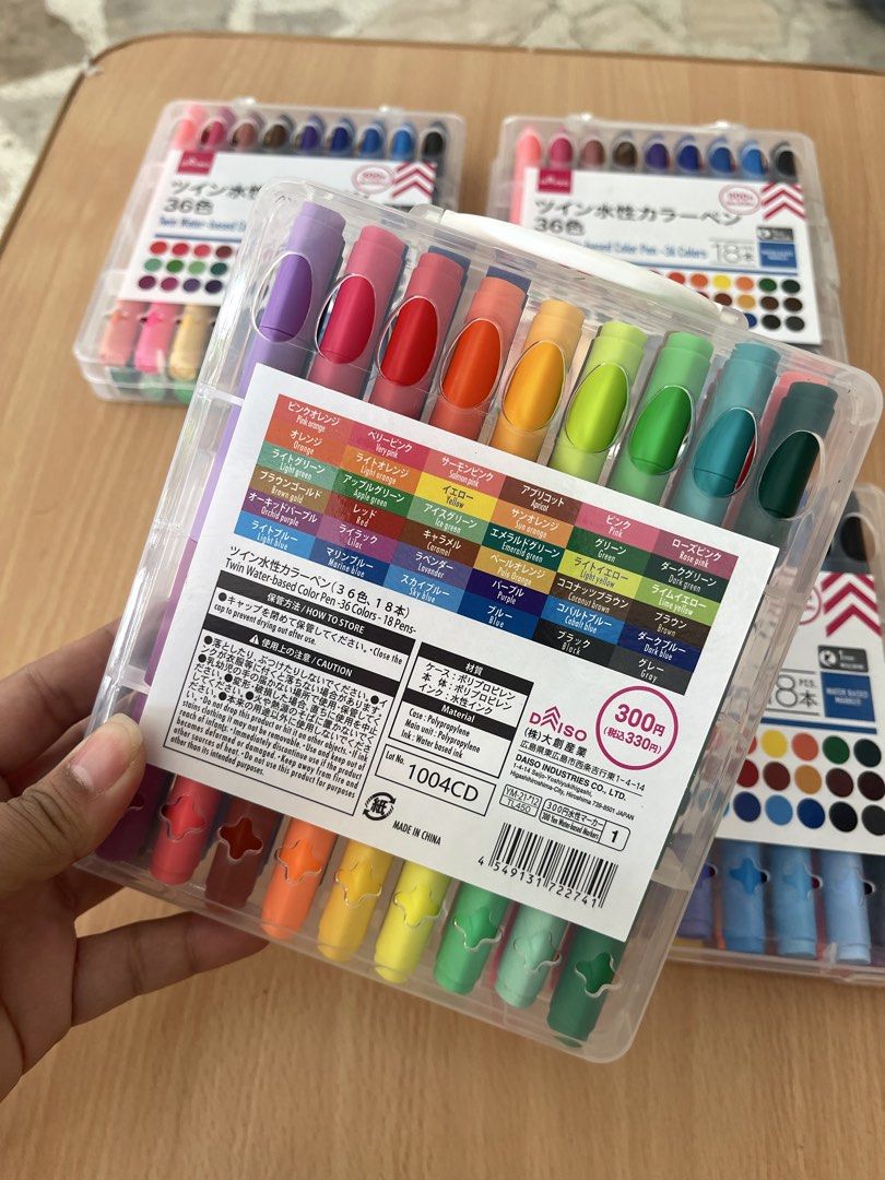Daiso Twin Water-based Color Pens (Category: Stationery & School Supplies) located in San Fernando. Submitted by japansurpluselyu (Listing ID 1422263855, Image 2). Description: Daiso Twin Water-based Color Pens featuring 36 colors from 18 double-sided markers. Price: 300 Yen (excluding tax). Features: Water-based ink with a fine 1mm tip for detailed work. Packaging: 18 markers are housed in a clear plastic case. Purpose: Suitable for coloring, wr