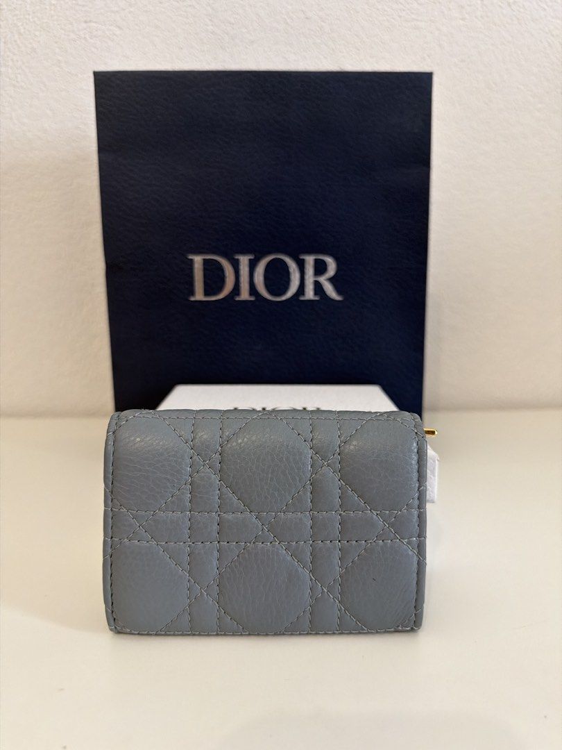Dior Lady Dior Wallet (Category: Luxury Bags & Wallets) located in Manila. Submitted by justabagxoxo (Listing ID 1422272206, Image 3). Description: - Authentic Lady Dior wallet - Light blue exterior with gold-tone hardware - Iconic Cannage stitching - Snap closure - Zipped compartment - Christian Dior Paris logo inside - Includes original box and shopping bag.