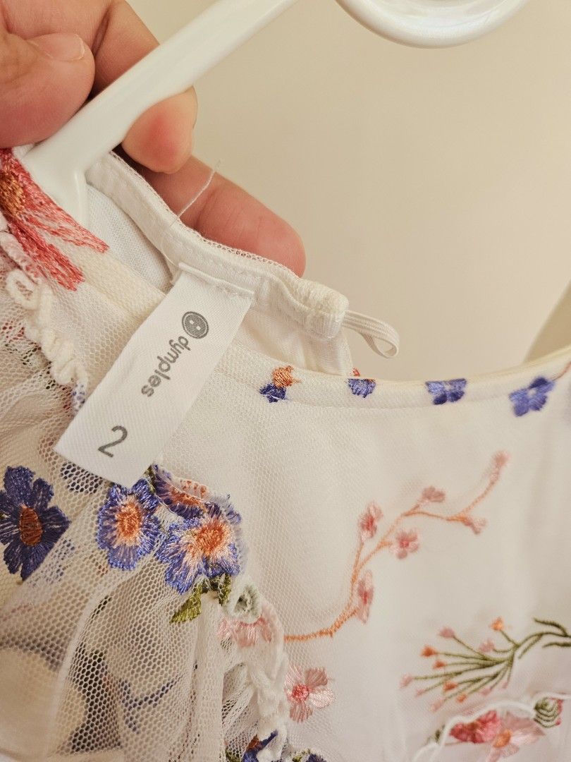 Dymples Floral Embroidered Dress Size 2 (Category: Babies & Kids Fashion) located in Manila. Submitted by teilybam (Listing ID 1422381086, Image 2). Description: - Dymples dress with floral embroidery - Size 2 - Features a ruffled neckline and sleeves - Color: White with pink and blue floral details - Lightweight and airy - Ideal for special occasions or everyday wear.