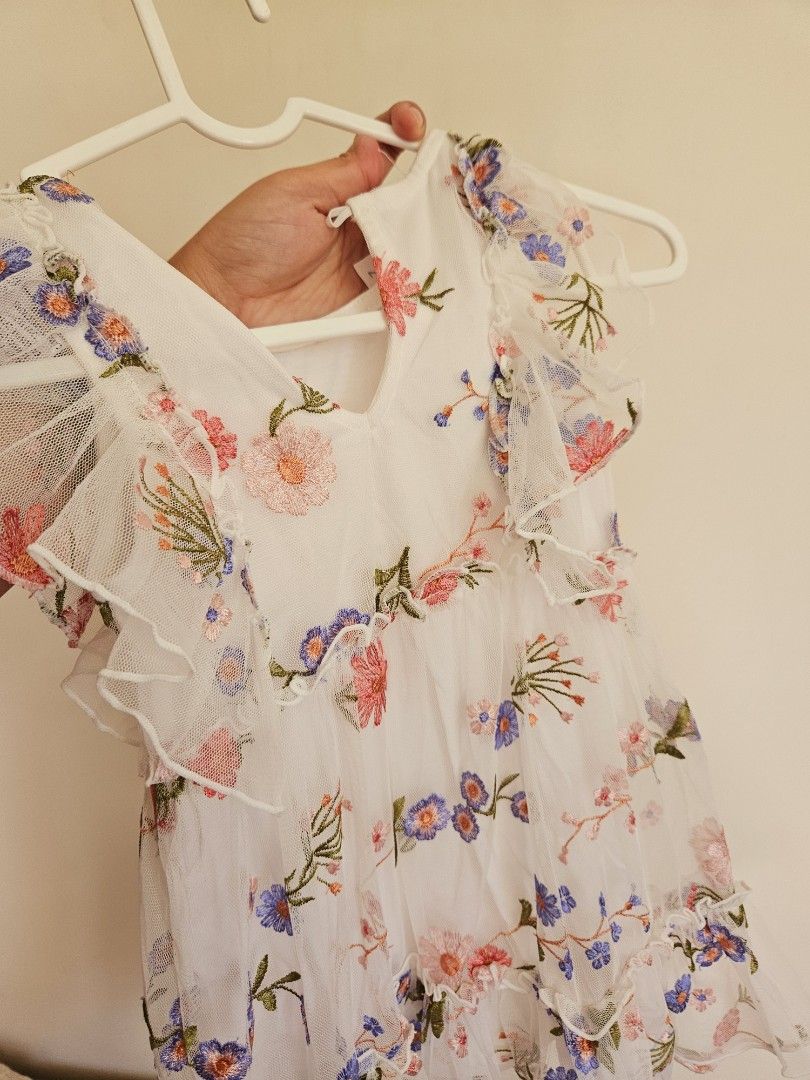 Dymples Floral Embroidered Dress Size 2 (Category: Babies & Kids Fashion) located in Manila. Submitted by teilybam (Listing ID 1422381086, Image 3). Description: - Dymples dress with floral embroidery - Size 2 - Features a ruffled neckline and sleeves - Color: White with pink and blue floral details - Lightweight and airy - Ideal for special occasions or everyday wear.