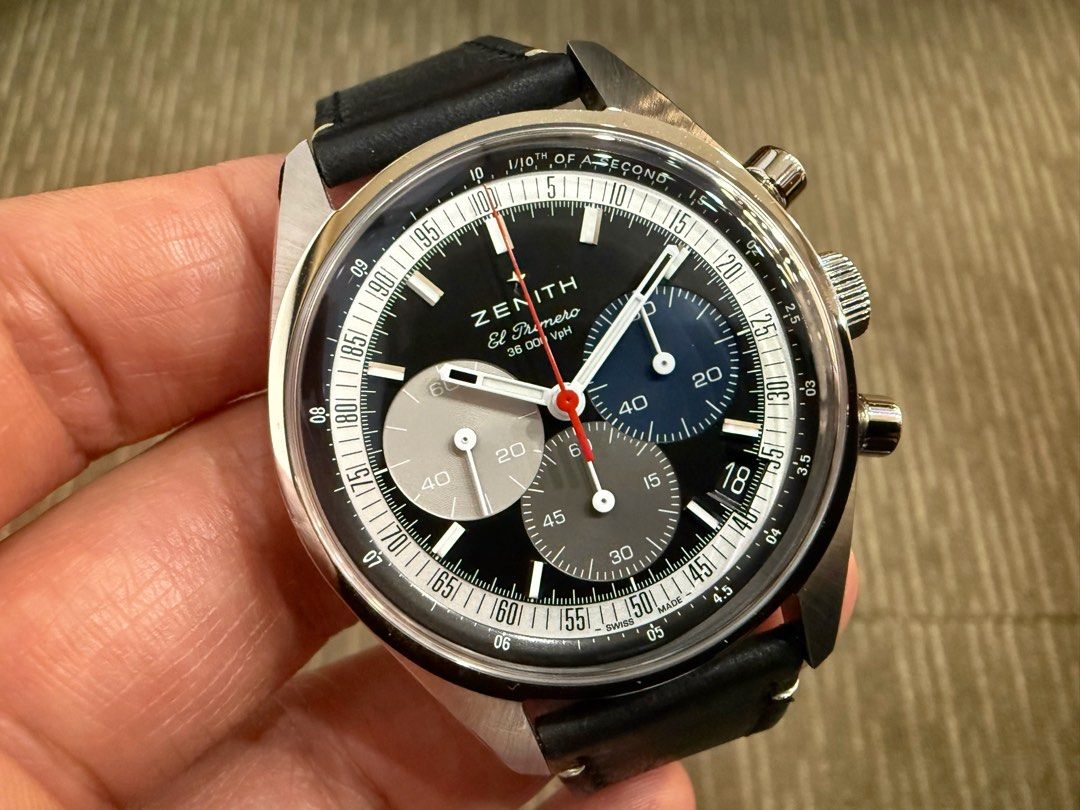 Feb 25 Zenith Chronomaster 38 El Primero Tricolour Chronograph Black Reverse Panda Date Automatic 03.3200.3600/22.C908 (Category: Watches) located in Singapore. Submitted by thetimeco (Listing ID 1422350866, Image 1). Description: Condition: Like New 9.5 / 10 Box Papers: Complete set dated Feb 2025. 5 years Zenith international warranty until Feb 2030. Original calf leather strap and deployant buckle in brand new condition. Additional original bl