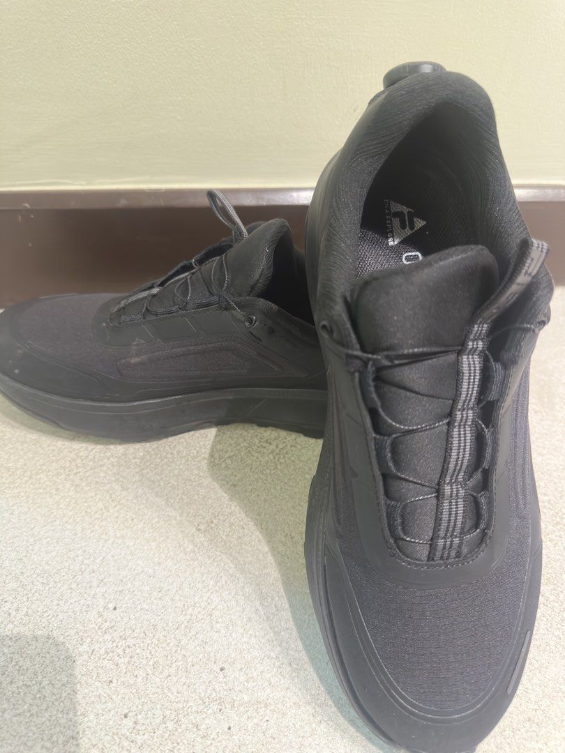Fila Running Shoes - Black (Category: Sneakers) located in Manila. Submitted by johnjohn9090 (Listing ID 1422329794, Image 2). Description: Black Fila running shoes. Features a unique lacing system. The size is US 9.5, EUR 43, UK 8.5, and CHN 270(2.5). Made in China. The shoes have a sleek, all-black design, suitable for various activities. The soles appear to be Vibram..