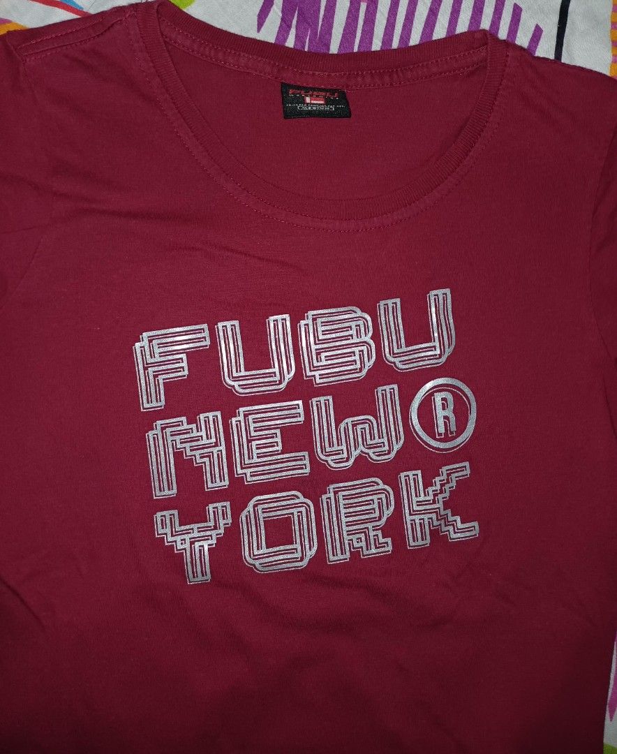 FUBU New York T-shirt - Medium (Category: Tshirts & Polo Shirts ) located in Manila. Submitted by 3Nel5 (Listing ID 1422352191, Image 3). Description: - FUBU New York T-shirt - Color: Maroon - Size: Medium - Features the FUBU logo in silver (outlined) - Crew neck and short sleeves - Plain maroon back - Made of soft material - Ideal for casual wear.