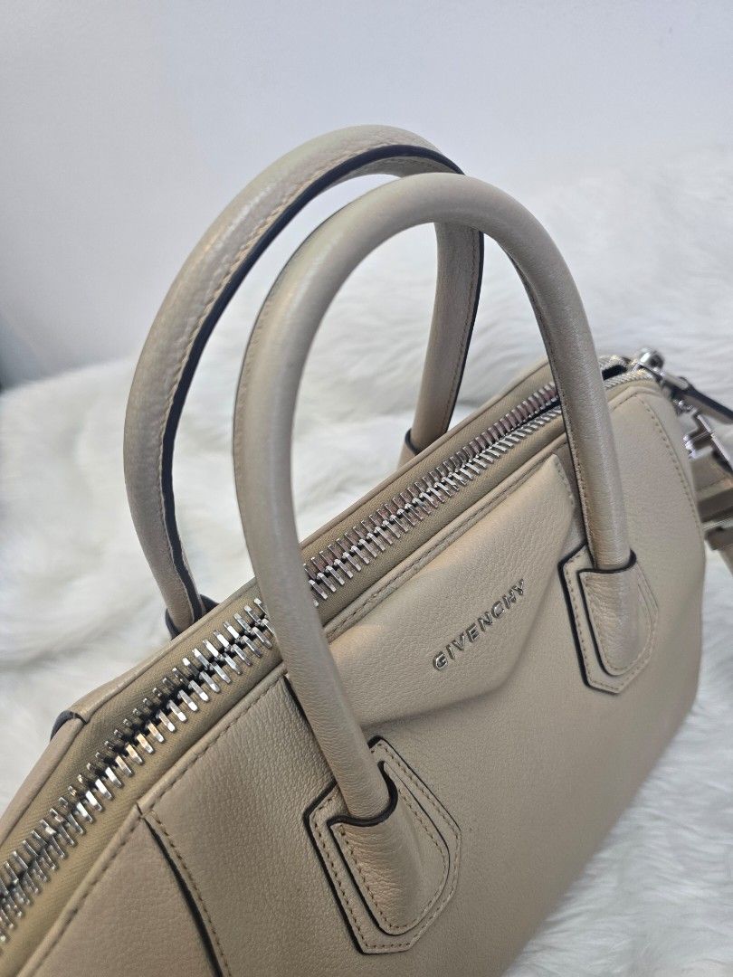 Givenchy Antigona Small Beige Satchel Bag (Category: Luxury Bags & Wallets) located in Taguig. Submitted by mluxeph (Listing ID 1422253113, Image 3). Description: Givenchy Antigona Small Beige Satchel Bag Gender: Ladies’ Material: Goatskin Leather Stamp: MP C 1109 Year: 2019 Interior: One zip pocket, two open pockets and one main compartment Measurements: 11”L X 6.5”W X 9.45”H Handle Drop: 3.75" Hardware: Silver Tone Inclusions: Original dust bag
