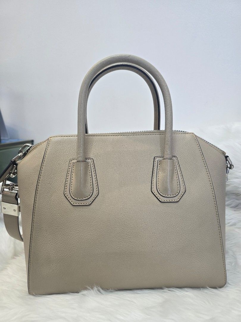 Givenchy Antigona Small Beige Satchel Bag (Category: Luxury Bags & Wallets) located in Taguig. Submitted by mluxeph (Listing ID 1422253113, Image 2). Description: Givenchy Antigona Small Beige Satchel Bag Gender: Ladies’ Material: Goatskin Leather Stamp: MP C 1109 Year: 2019 Interior: One zip pocket, two open pockets and one main compartment Measurements: 11”L X 6.5”W X 9.45”H Handle Drop: 3.75" Hardware: Silver Tone Inclusions: Original dust bag