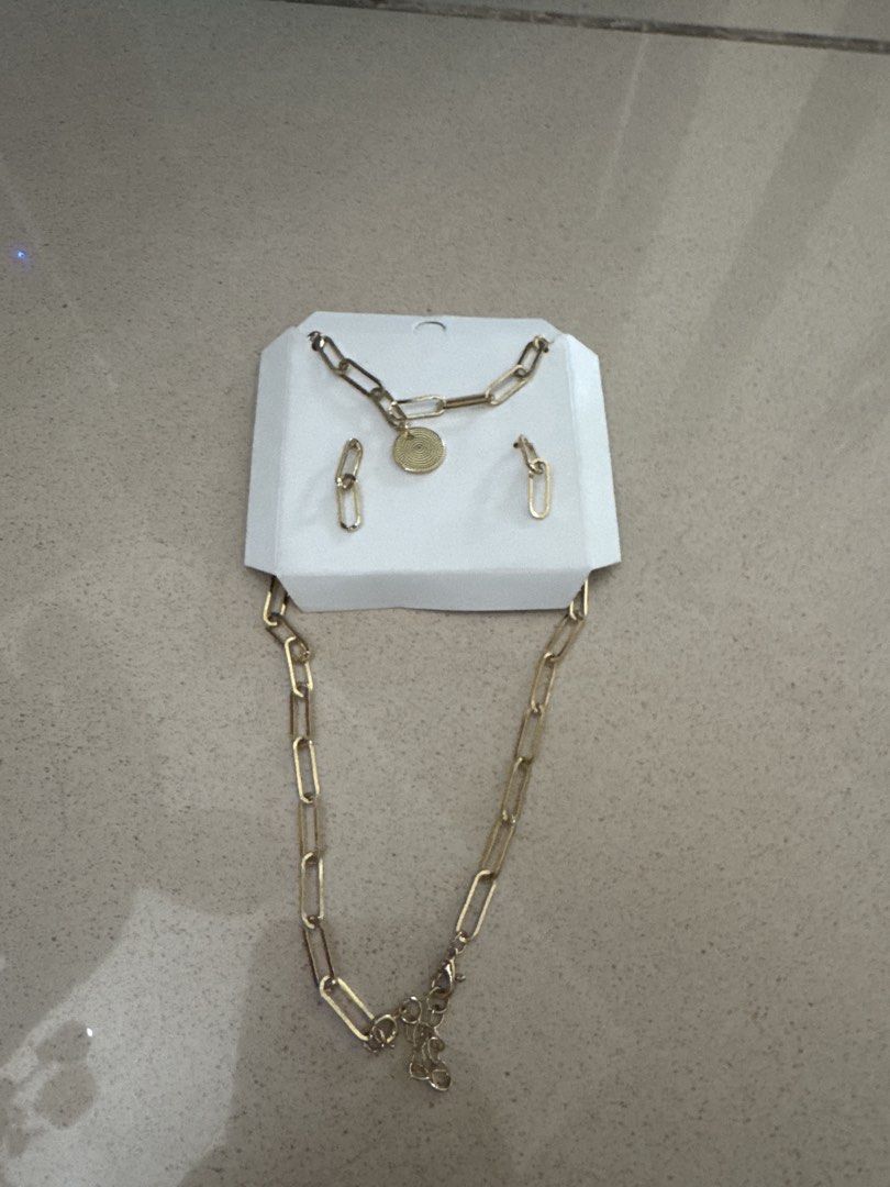 Gold Chain Necklace and Earrings Set (Category: Necklaces) located in Quezon City. Submitted by happibruce (Listing ID 1422263773, Image 1). Description: - Gold chain necklace with pendant - Matching simple earrings - Adds sophistication to any outfit - Versatile for casual and formal wear.