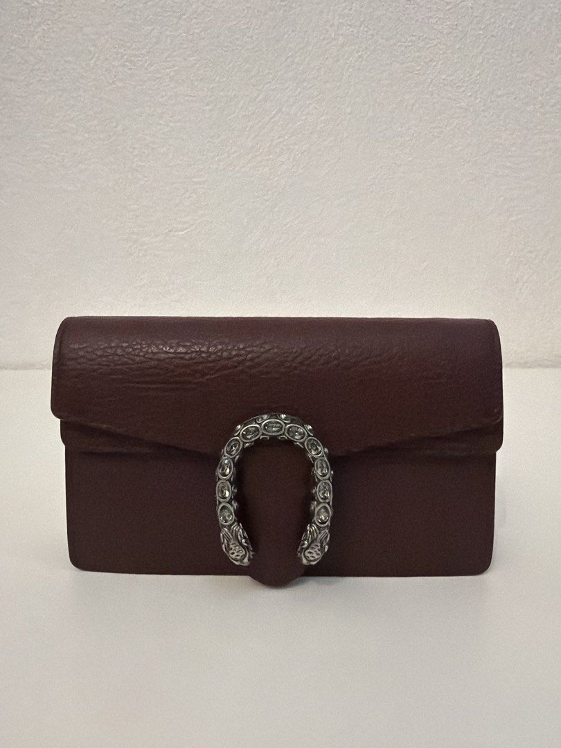 Gucci Dionysus Super Mini Bag (Category: Luxury Bags & Wallets) located in Manila. Submitted by justabagxoxo (Listing ID 1422279744, Image 1). Description: - Gucci Dionysus Super Mini Bag - Burgundy leather exterior - Crystal-embellished horseshoe closure - Chain strap - Compact interior - Flap closure - Silver-toned hardware - Interior pocket.