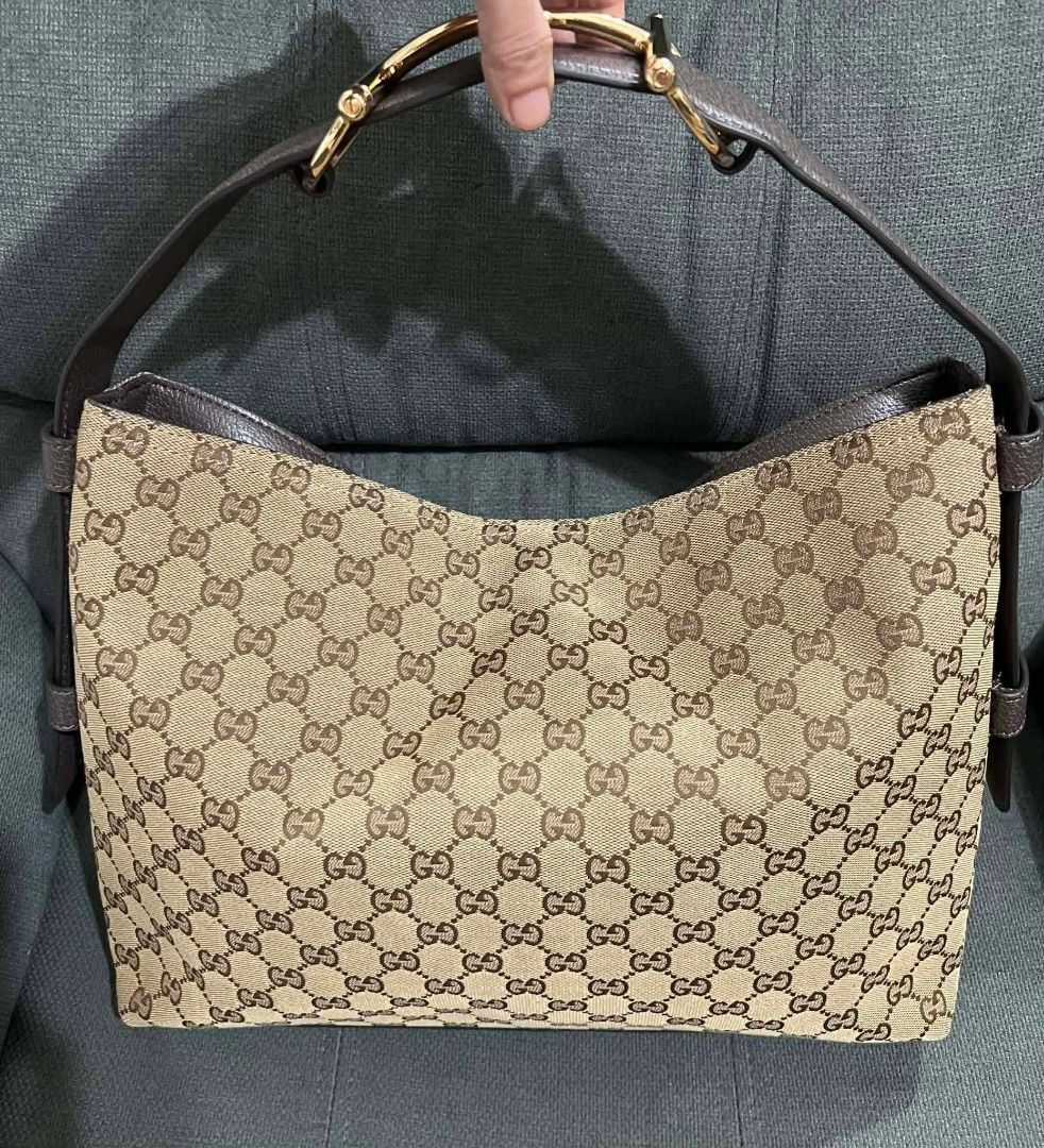 Gucci Canvas Hobo Bag (Category: Luxury Bags & Wallets) located in Quezon City. Submitted by luxxechic (Listing ID 1422281825, Image 1). Description: with serial code gucci under zip with black etiketa with dust bag good as new size:L-15in/H-11in no issue Japan preloved actual photo poated mop: gcash.