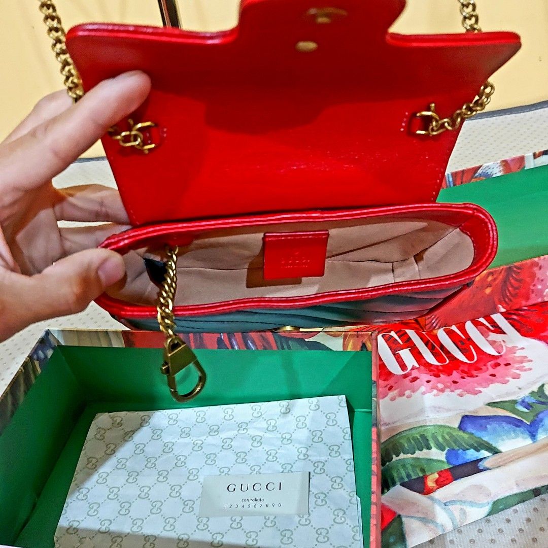 Gucci GG Marmont Mini Bag (Category: Luxury Bags & Wallets) located in La Trinidad. Submitted by marksols (Listing ID 1422244802, Image 3). Description: - Black quilted leather mini bag with red trim - Gold-tone chain strap - Iconic GG logo - Includes original box and dust bag - Red leather interior.