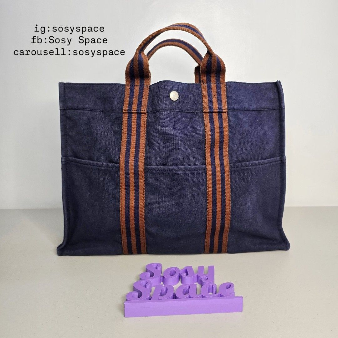 Hermes Navy Blue Canvas Tote Bag (Category: Luxury Bags & Wallets) located in Lucena. Submitted by sosyspace (Listing ID 1422304628, Image 2). Description: H. E. R. M. E. S. L15082304B1P159 Navy Blue Fourre Tout MM Tote Bag 100% Heavy Duty Cotton Brown Stripes Webbing Hand Bag 42 x 10 x 31 cm Inclusion: none Condition: PRELOVED Has minor signs of use Still Excellent Condition for me. Price: Php 18,500 + HF + SF (Best Price Already. No More Haggli