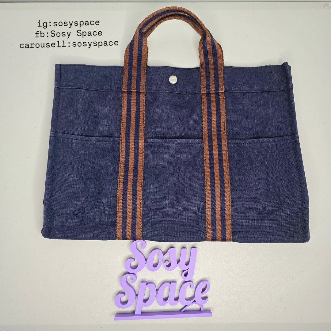 Hermes Navy Blue Canvas Tote Bag (Category: Luxury Bags & Wallets) located in Lucena. Submitted by sosyspace (Listing ID 1422304628, Image 1). Description: H. E. R. M. E. S. L15082304B1P159 Navy Blue Fourre Tout MM Tote Bag 100% Heavy Duty Cotton Brown Stripes Webbing Hand Bag 42 x 10 x 31 cm Inclusion: none Condition: PRELOVED Has minor signs of use Still Excellent Condition for me. Price: Php 18,500 + HF + SF (Best Price Already. No More Haggli