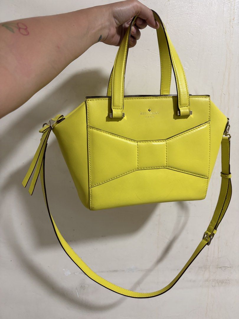 Kate Spade New York Bow Satchel (Category: Luxury Bags & Wallets) located in Manila. Submitted by dmmai (Listing ID 1422354627, Image 1). Description: - Bright yellow Kate Spade satchel - Bow detail on the front - Top handle and detachable shoulder strap - Polka dot lining - Silver hardware - Zipper closure - Protective metal feet Flaws as in the pictures, very minor, overall still a great bag.