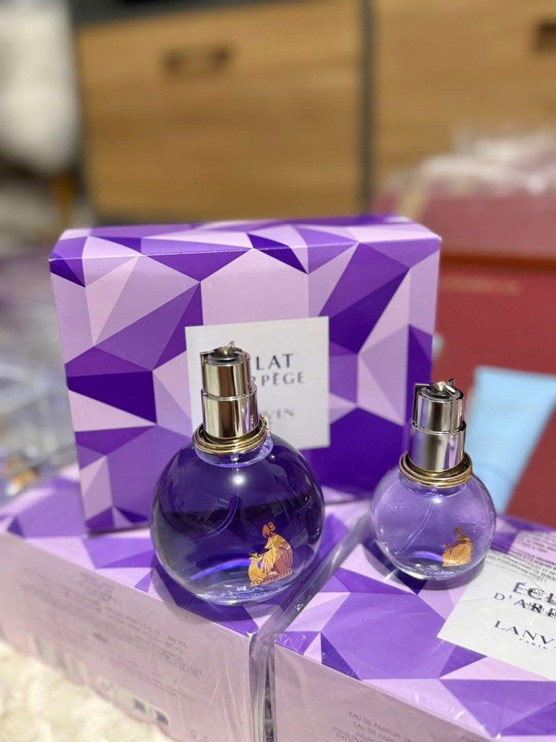 Lanvin Eclat D'Arpege Eau de Parfum (Category: Fragrance & Deodorants) located in Manila. Submitted by clairetot (Listing ID 1422372006, Image 1). Description: Original Set of Lanvin Eclat D'Arpege Eau de Parfum. Includes a full-sized bottle and a smaller travel-sized bottle. The bottles are round with a purple liquid and gold accents. The set comes in a purple geometric patterned box. The box has the Lanvin logo and product name printed on it..