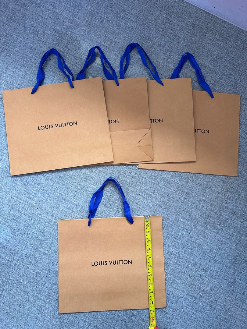 Louis Vuitton Paper Bags (Category: Luxury Bags & Wallets) located in Paranaque City. Submitted by mumziella (Listing ID 1422273736, Image 3). Description: - Louis Vuitton paper bags - 200 EACH - Features the iconic Louis Vuitton logo - Includes blue ribbon handles - L27cm x W32cm - Ideal for gifting or collecting.