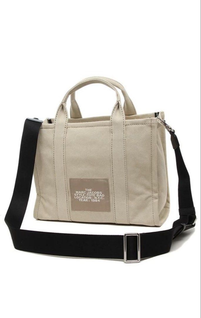 Marc Jacobs The Tote Bag (Category: Luxury Bags & Wallets) located in Bacoor. Submitted by 9gee9 (Listing ID 1422304993, Image 2). Description: - Authentic Marc Jacobs The Tote Bag - Neutral beige color - Medium size - Top handle and detachable shoulder strap - Secure zipper closure - Interior pocket for organization - Signature Marc Jacobs logo - Crafted from durable canvas material - Price negotiable for sure buyer - RFS: decluttering.
