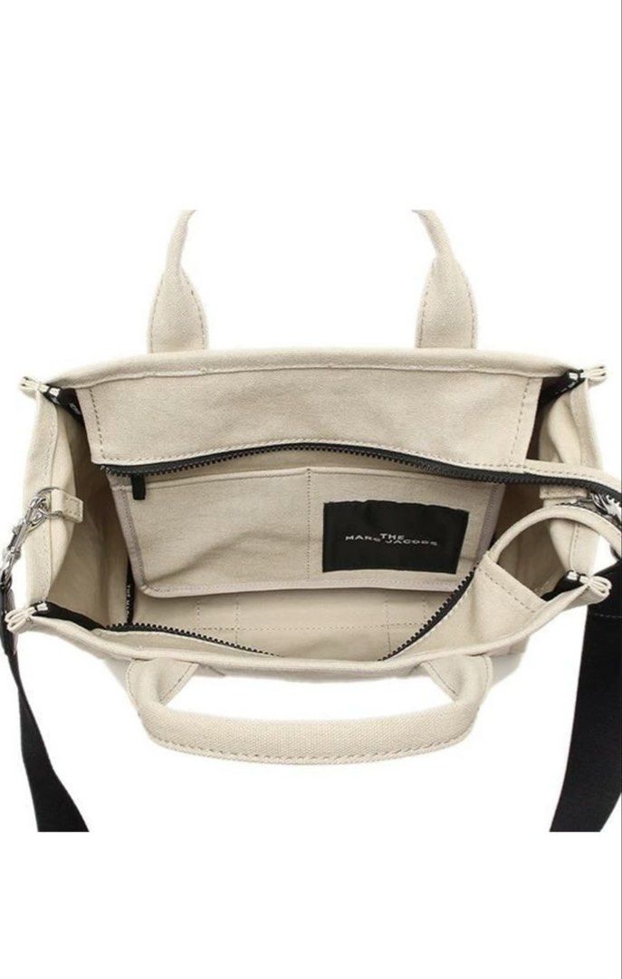 Marc Jacobs The Tote Bag (Category: Luxury Bags & Wallets) located in Bacoor. Submitted by 9gee9 (Listing ID 1422304993, Image 3). Description: - Authentic Marc Jacobs The Tote Bag - Neutral beige color - Medium size - Top handle and detachable shoulder strap - Secure zipper closure - Interior pocket for organization - Signature Marc Jacobs logo - Crafted from durable canvas material - Price negotiable for sure buyer - RFS: decluttering.
