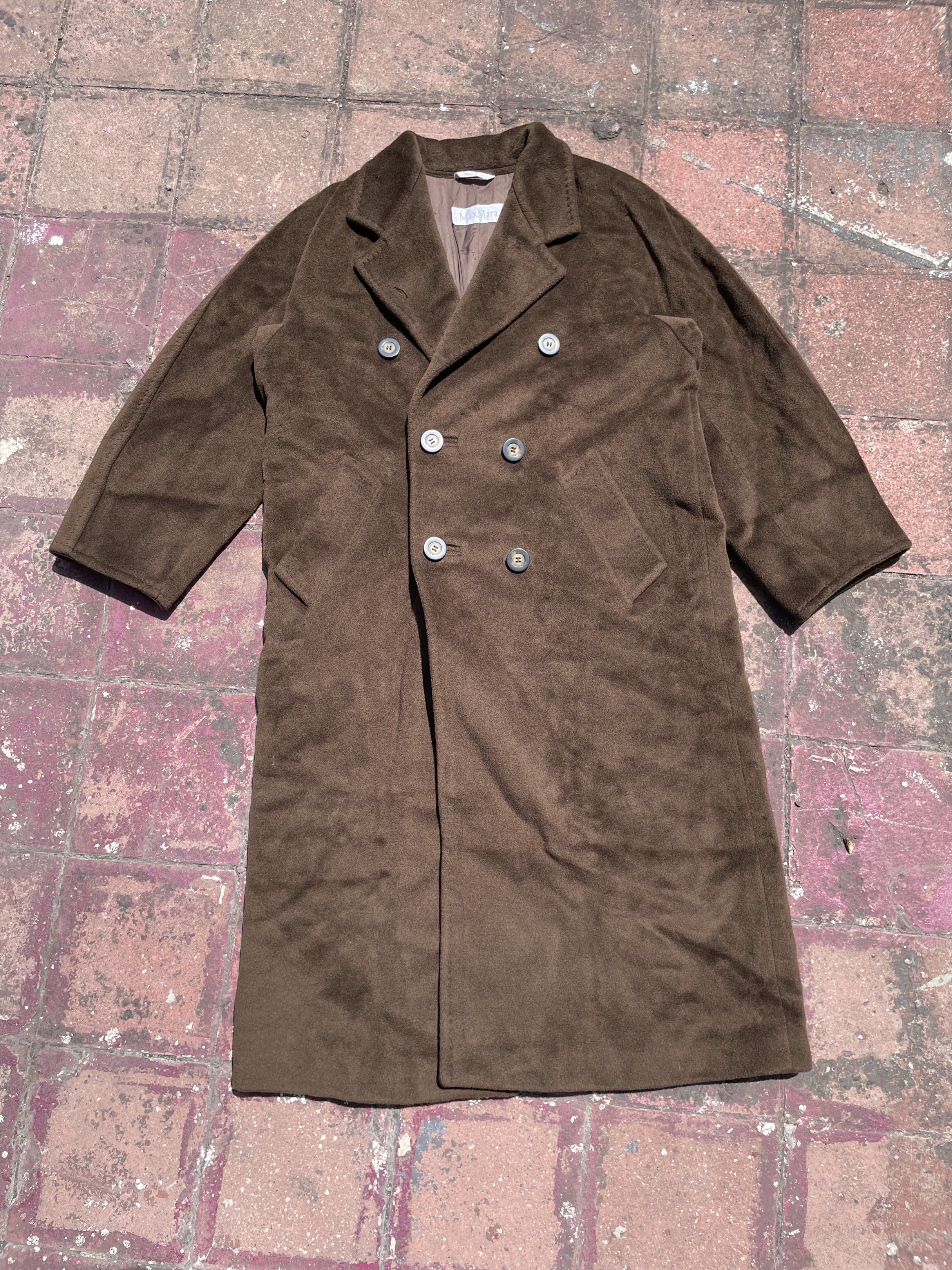 Max Mara Brown Wool Trench Coat (Category: Luxury Apparel) located in Taguig. Submitted by highlows (Listing ID 1422300548, Image 1). Description: - Max Mara double-breasted coat - Rich brown color - Classic design with notched lapel - Made in Italy - Satin lining - Size: US 6, UK 8, IT 40 - Minor imperfections (small holes).